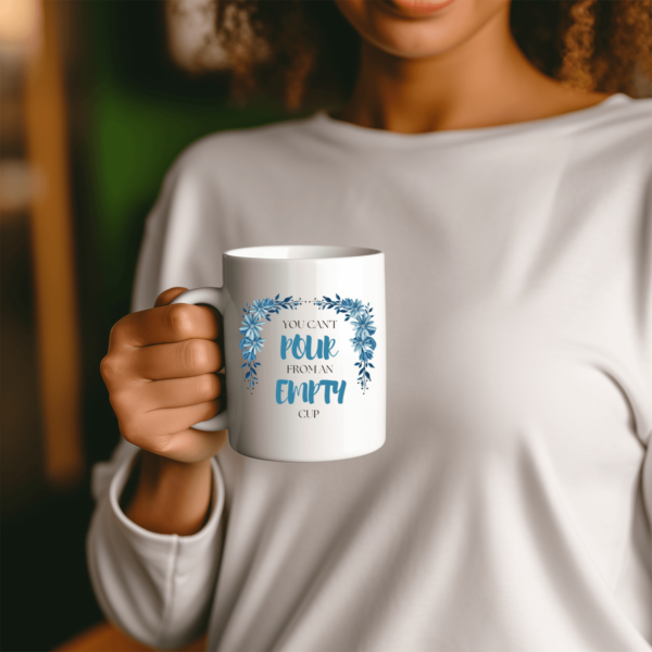 Woman holding self-care coffee mug